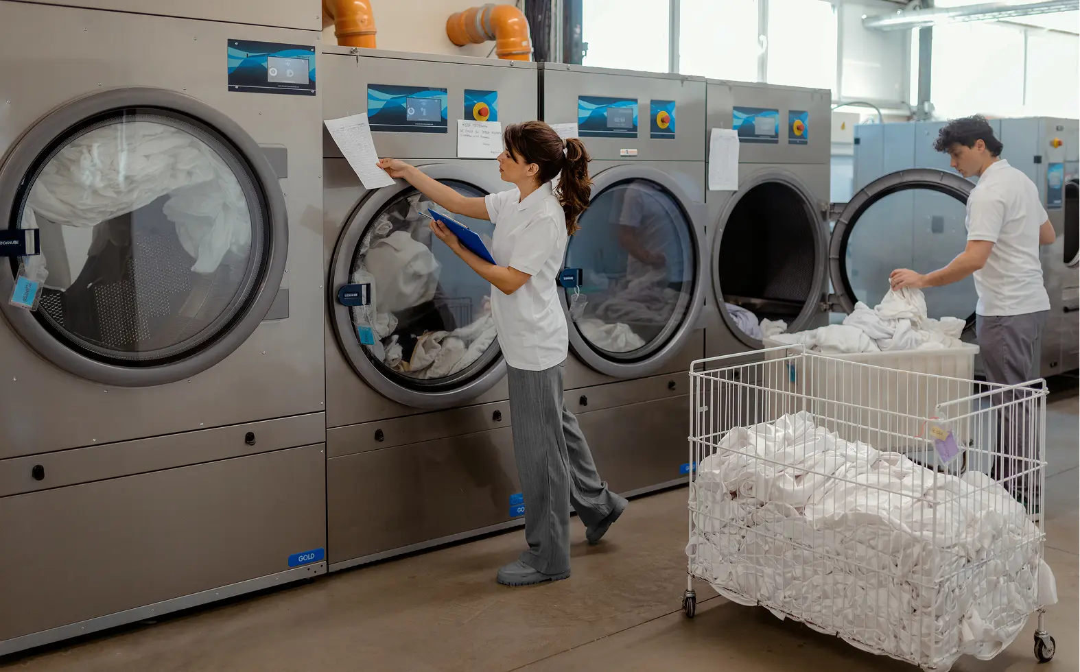 Workers sorting and washing linens